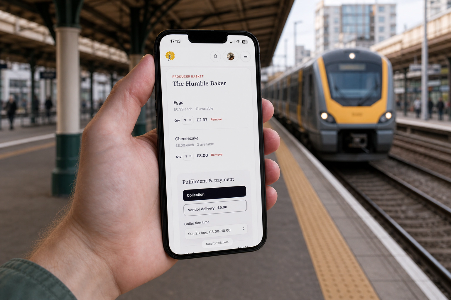 foodforfolk basket and collection time open on a phone as a train arrives at a station